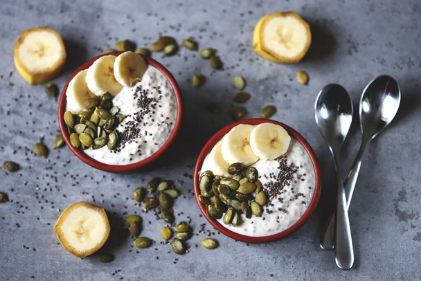 Chia pudding with pumpkin seeds and banana. Healthy breakfast or snack. Keto diet. Keto dessert. Sugar free dessert. - Photo, Image