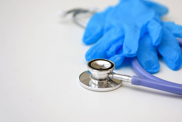 Stethoscope and gloves on a white background. Close up. - Fotó, kép