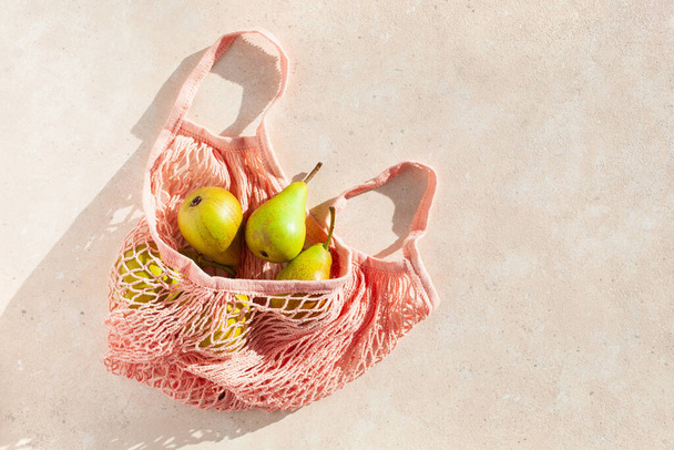 fruits pears in reusable mesh cotton bag, plastic free zero waste concept - Photo, Image