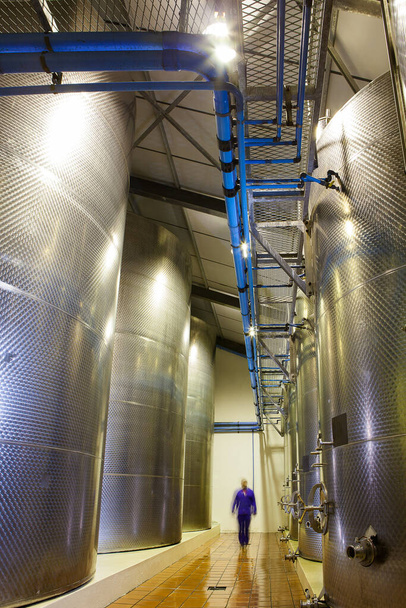 Wide angle view of Stainless Steel wine tanks in a winery in the Breede Valley in the Western Cape of South Africa - 写真・画像