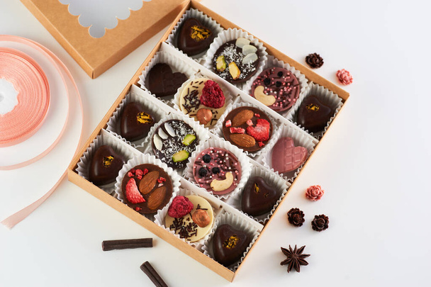 handmade chocolates, fruit and nuts, heart-shaped milk and dark chocolate - Фото, изображение