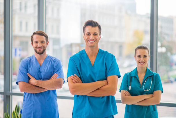 Group of doctors standing and looking positive - Photo, image