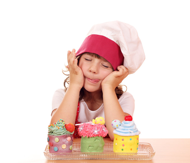 Little girl cook enjoying sweet cupcakes - Photo, Image