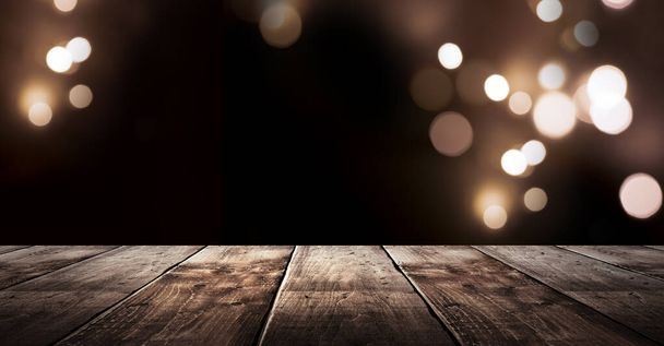 Wooden holiday empty table, night view, blurred bokeh lights background. - Photo, image
