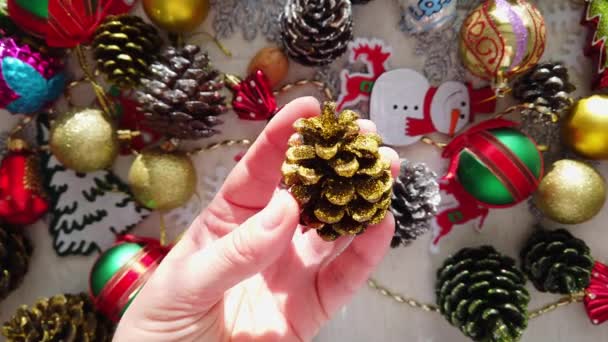 Glass, plastic, Christmas tree decorations on table. Womens hands. Close-up - Footage, Video