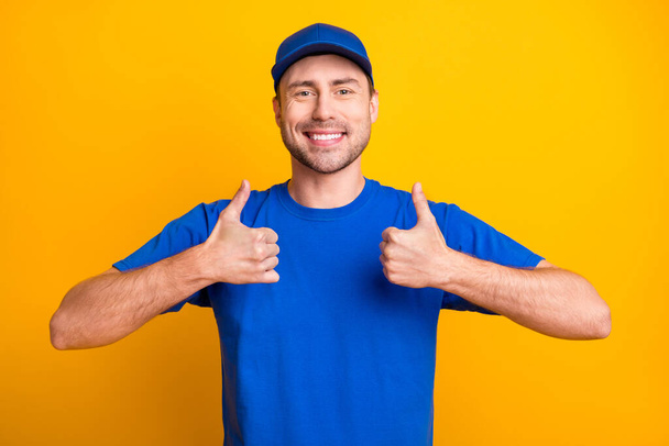 Portrait of cheerful handsome guy show two hands thumbs up toothy smile isolated on yellow color background - Zdjęcie, obraz