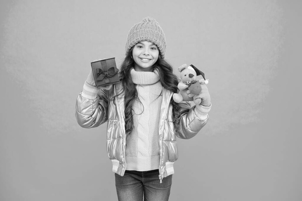 online purchase bonus. happy small girl present. shopping on xmas season. merry christmas. happy new year. Feeling grateful for good gift. fashion kid in trendy puffer jacket. warm winter clothes - Foto, imagen