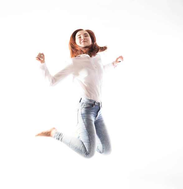 Teenage long hair girl jumping on white background. - Fotoğraf, Görsel