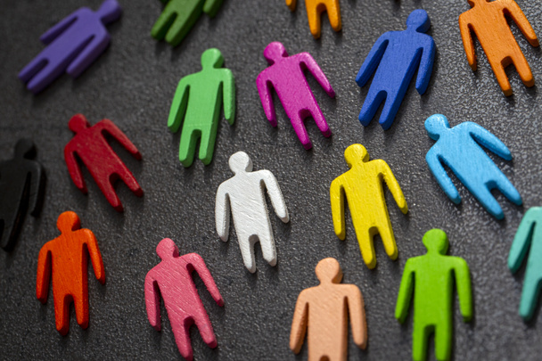 Equality and diversity concept. Multi-colored wooden figurines on a blackboard. - Photo, Image