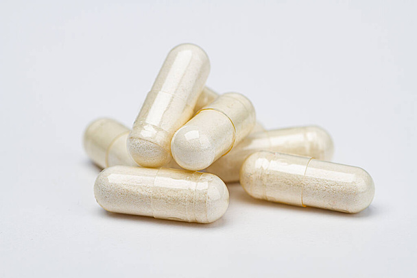 σωρός από διαφανή χάπι γεμάτο με λευκά συστατικά - Φωτογραφία, εικόνα