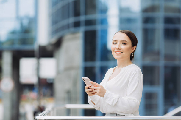 Businesswoman sending message with smartphone - Photo, image