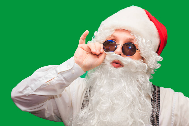 Portrait of stylish Santa Claus on color background - 写真・画像
