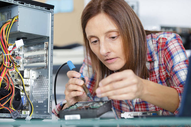 female computer technician using a soldering iron - Photo, Image