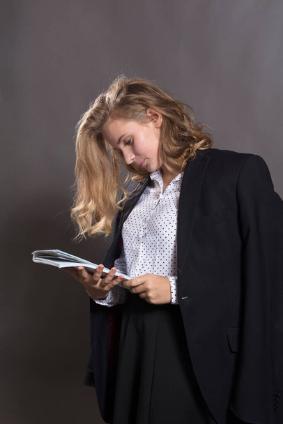 Young beautiful longhaired college girl with papers and jacket on her shoulders - Foto, imagen