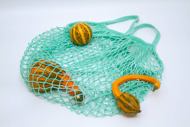 Decorative pumpkins in a mesh shopping bag - Fotografie, Obrázek