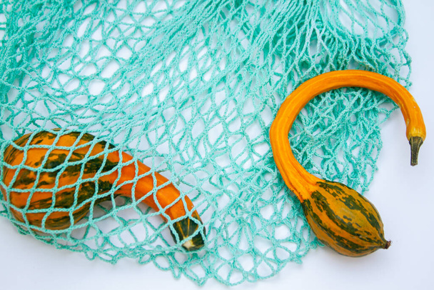 Decorative pumpkins in a mesh shopping bag - Φωτογραφία, εικόνα