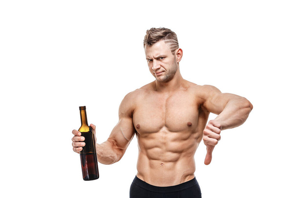 Sporty man holding a wine and milk and faces a choice, healthy lifestyle or alcohol. Health, sports, choice, healthy food and healthy lifestyle concept - Photo, Image