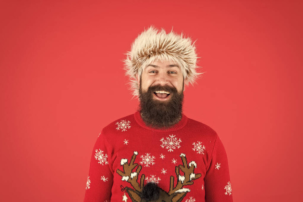 Man with long beard and mustache. Winter care. Emotional guy. Winter mood. Bearded hipster wear knitted sweater and furry hat. Weather forecast. Winter fashion. Cold days. Barbershop services - Foto, Bild
