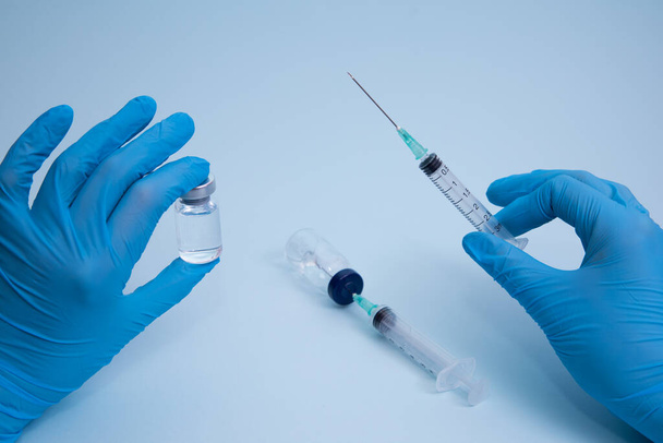 Koncepcja zwalczania wirusa covid-19 wirusa korony, naukowiec w laboratorium trzymający strzykawkę z płynnymi szczepionkami dla dzieci lub starszych dorosłych. - Zdjęcie, obraz