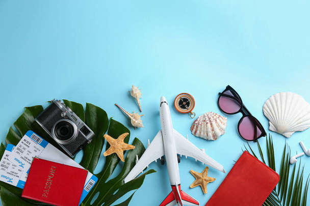Flat lay composition with toy airplane and travel items on light blue background. Space for text - Foto, imagen