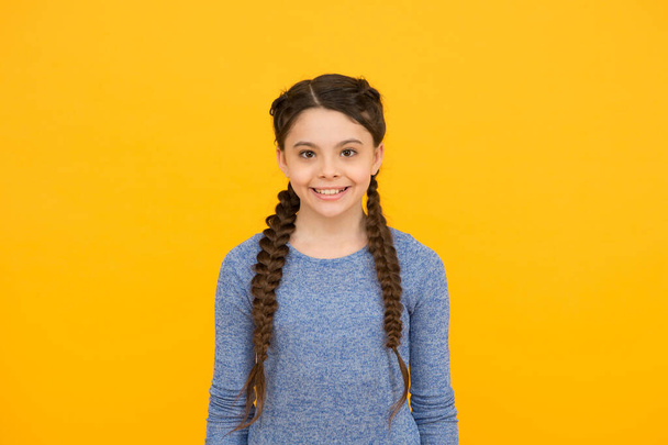 happy teen girl with braided hair wear casual style on yellow background, fashion - Foto, Imagem