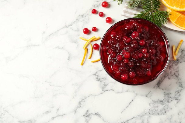 Flat lay composition with cranberry sauce on white marble table. Space for text - Foto, Bild
