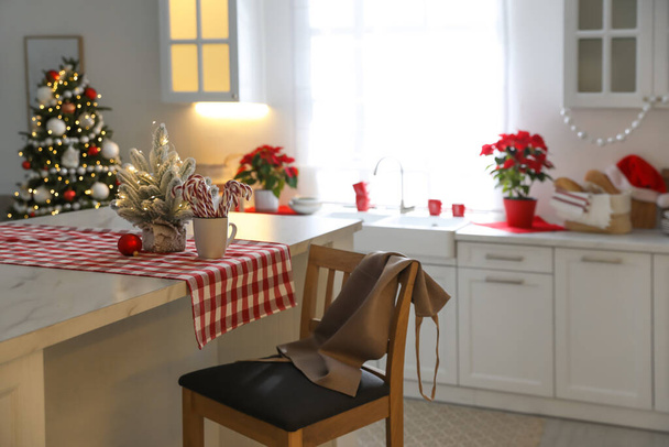 Beautiful kitchen interior with Christmas tree and festive decor - Valokuva, kuva