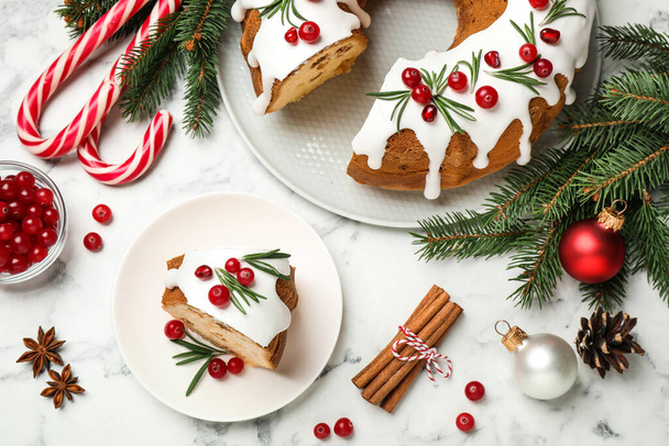 Flat lay composition with traditional homemade Christmas cake on white marble table - Фото, изображение