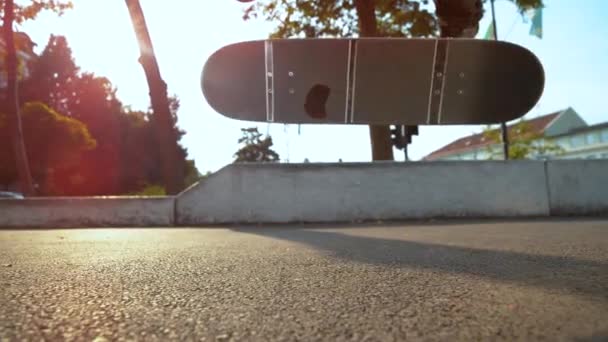 CLOSE UP: Unrecognizable skateboarder lands a 360 flip during freestyle session. - Footage, Video