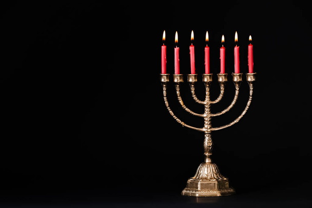 Golden menorah with burning candles on black background, space for text - Foto, immagini