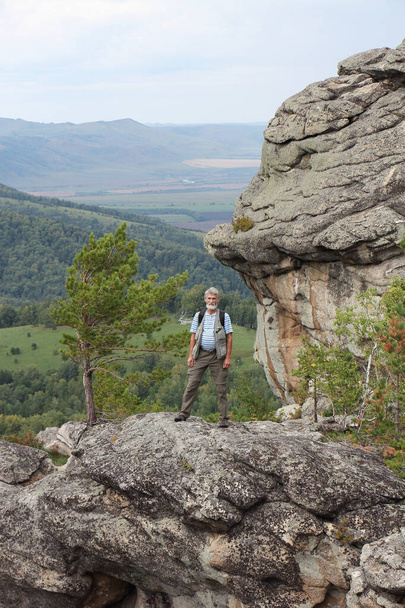 Happy man standing on the Ambarchiki rock, Belokurikha 2, Altai Mountains, Russia  - Фото, зображення