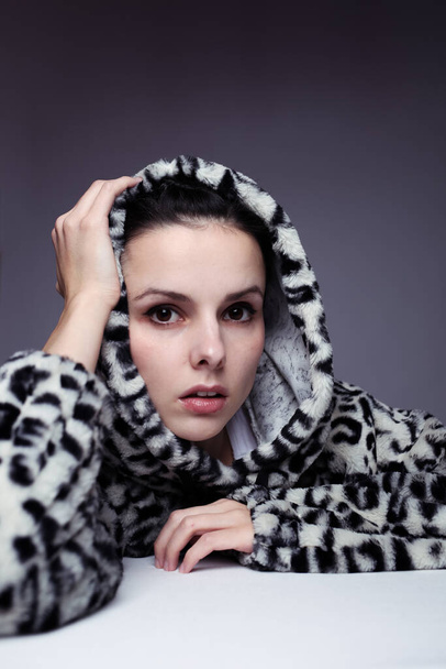 woman in a sweatshirt with a hood, light background - Foto, immagini