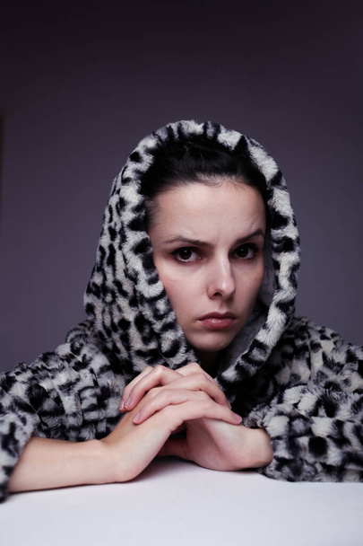 woman in a sweatshirt with a hood, light background - Photo, image