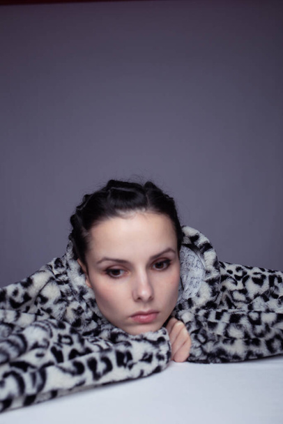 portrait of a girl in a hoodie, gray background - Foto, Imagem