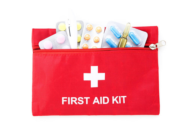 First aid kit with medical supplies isolated on white background - Foto, Bild