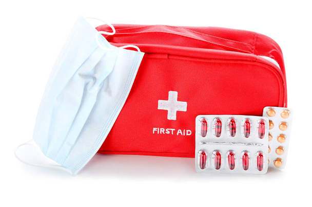 First aid kit with medicine mask and pills isolated on white background - 写真・画像