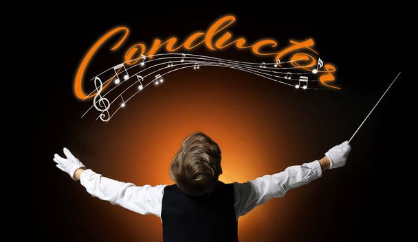 Little conductor and note signs on dark color background - Photo, Image