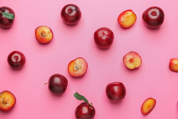 Fresh ripe plums on color background - 写真・画像