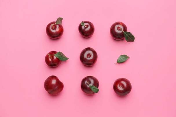 Fresh ripe plums on  color background - Фото, зображення