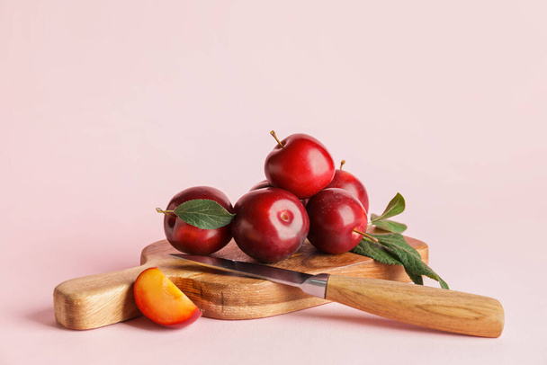 Tablero con ciruelas maduras frescas sobre fondo de color - Foto, imagen
