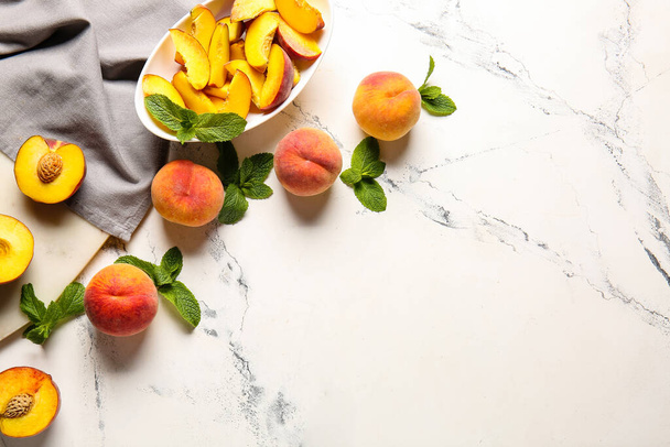 Composition with whole and cut ripe peaches on table - Foto, afbeelding