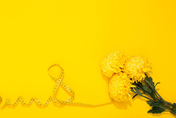 International Women's Day 8 March. World Mother's Day 8 May. Three lush chrysanthemums and a centimeter tape twisted in the shape of the number 8. Greeting card with space for text. - Photo, image