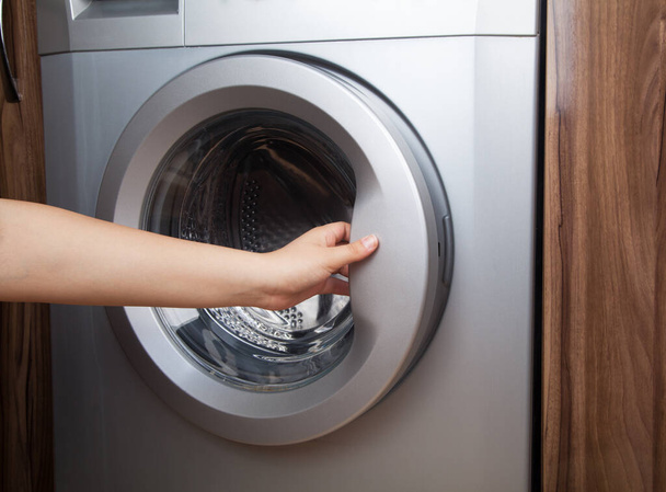  Woman using washing machine. Washing machine at home. - Photo, Image