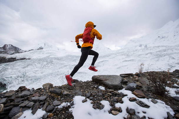 Woman trail runner cross country running on high altitude mountain ridge - Fotografie, Obrázek