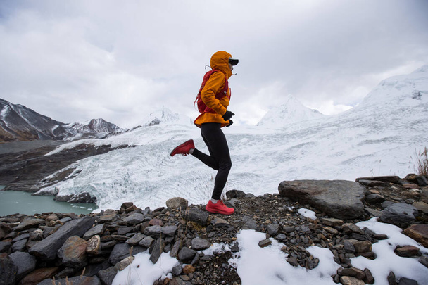 Woman trail runner cross country running on high altitude mountain ridge - Fotografie, Obrázek