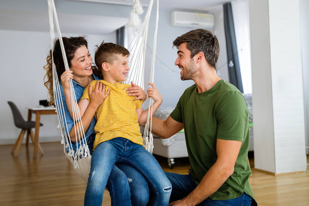 Happy young family having fun, playing together at home - Фото, изображение