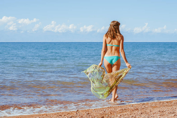 Woman with sarong on caribbean beach - 写真・画像