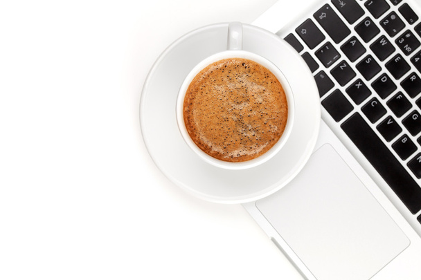 Cappuccino cup on laptop. Above view - Photo, image