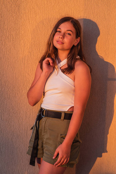 Portrait of Hipster Girl on Yellow Wall Background. Urban Fashion Concept. Teenage girl - Foto, Bild