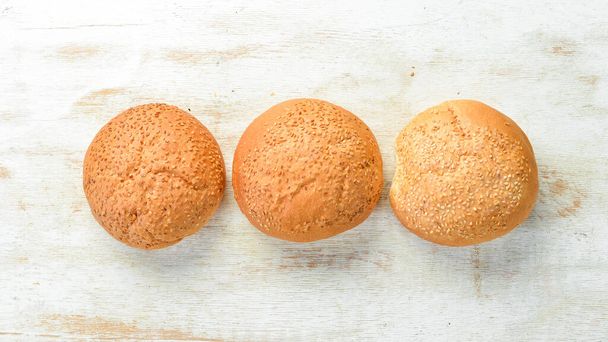 Bakery- fresh rolls for a burger. Baking from rye and flour. Top view. Rustic style. - Photo, image